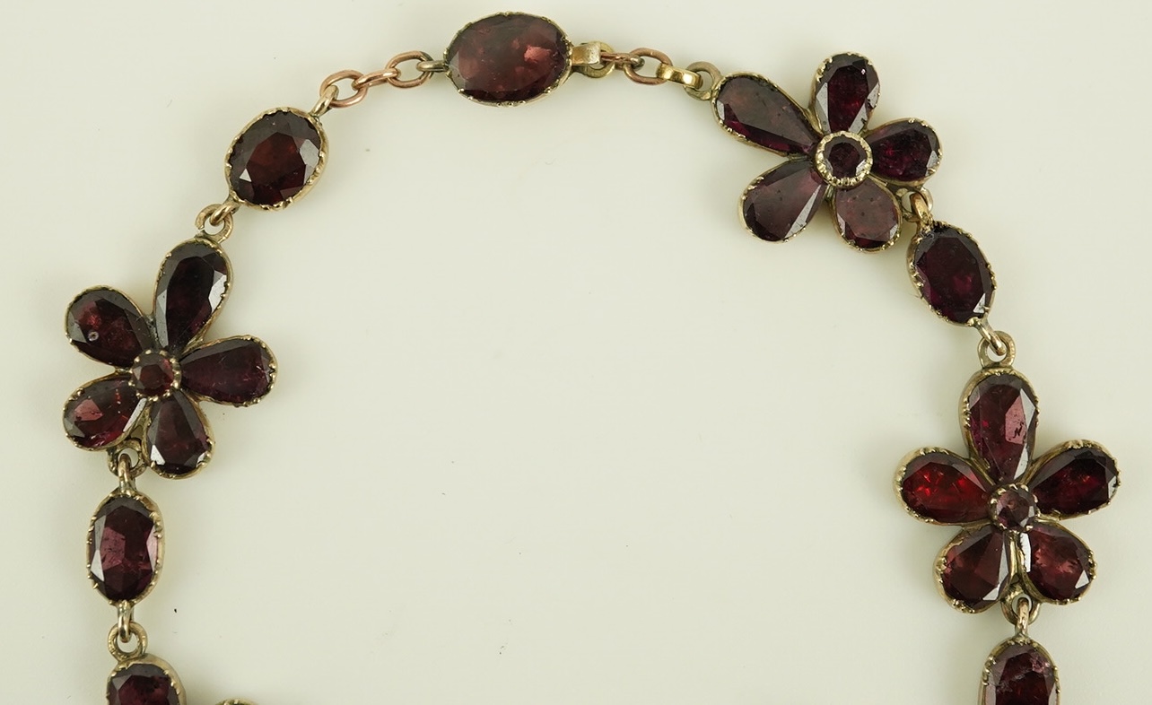 An early Victorian gold and foil backed garnet cluster set bracelet